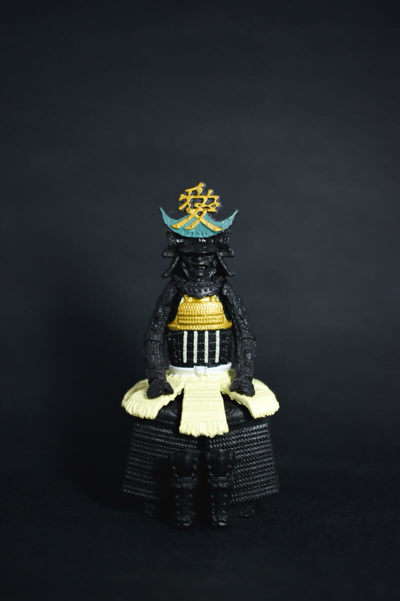 black, yellow, and blue deity figurine